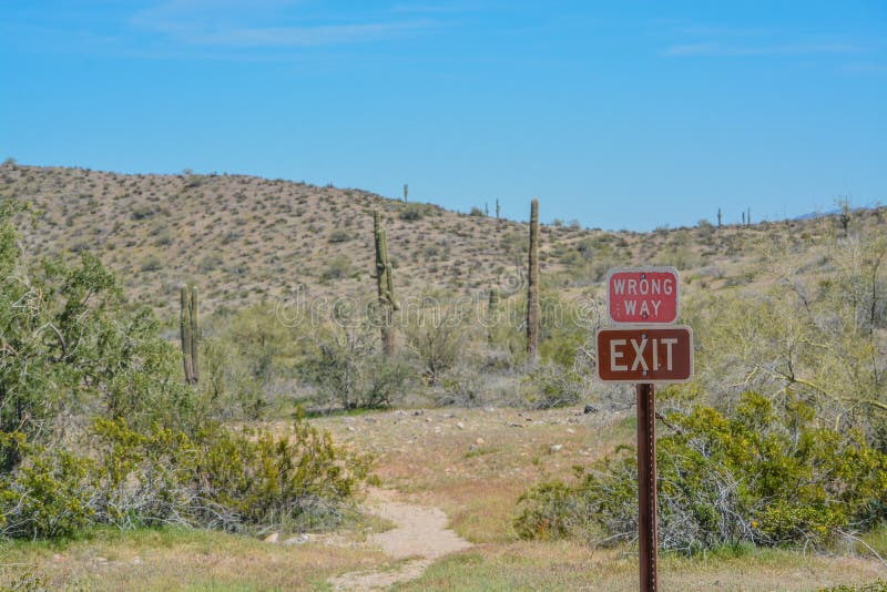 Wrong Way and Exit Signs at Estrella Mountain Regional Park in Goodyear, Maricopa County, Arizona USA.  royalty free stock photos