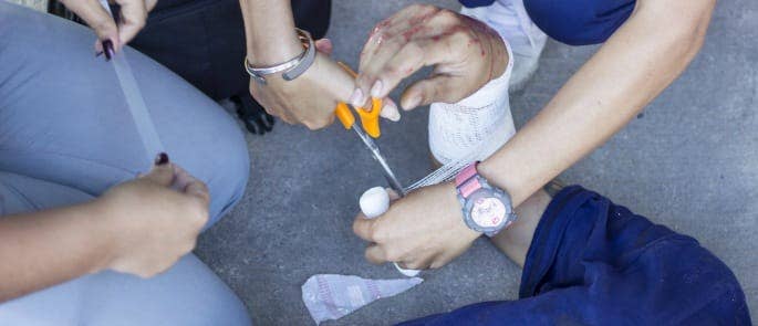 Construction first aid kit being used at the site of an injury